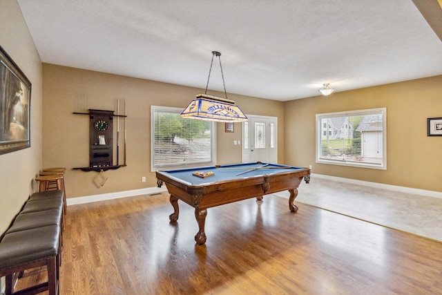 game room with hardwood / wood-style floors, a textured ceiling, and pool table