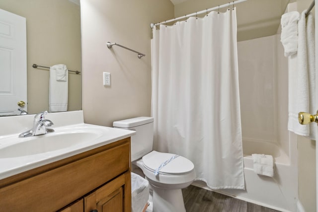 full bathroom with shower / bath combination with curtain, vanity, hardwood / wood-style flooring, and toilet