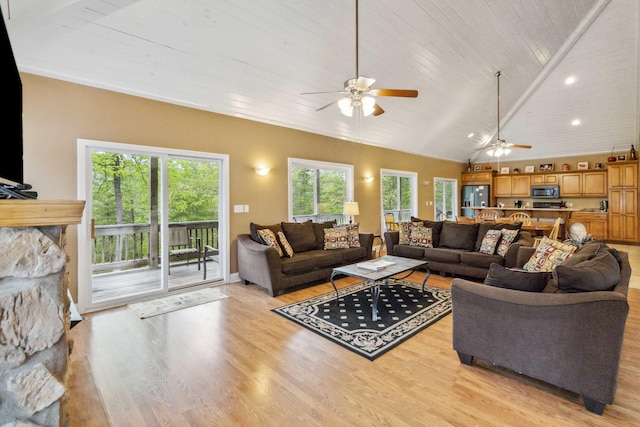 living room with light wood-type flooring, wooden ceiling, and a healthy amount of sunlight