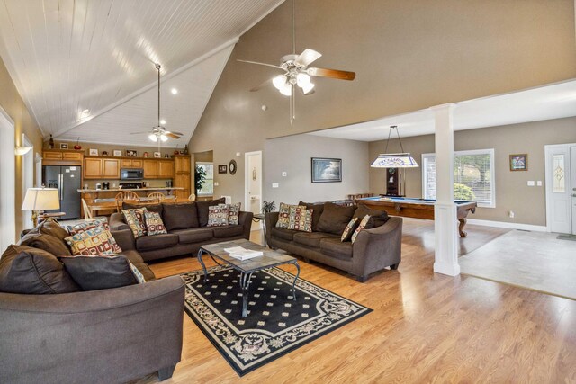 living room featuring high vaulted ceiling, ornate columns, billiards, and light hardwood / wood-style flooring