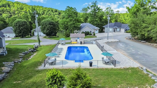 view of swimming pool with an outdoor structure and a yard