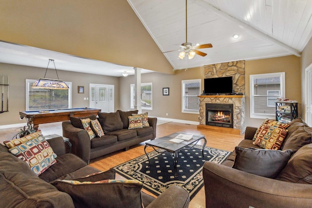 living room featuring ceiling fan, high vaulted ceiling, a fireplace, light hardwood / wood-style floors, and pool table