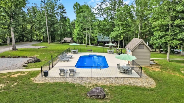 view of swimming pool featuring a patio area and a yard