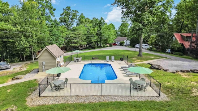 view of pool with a yard and a patio