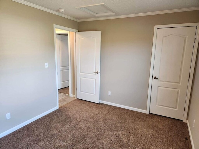 unfurnished bedroom with a textured ceiling and dark colored carpet