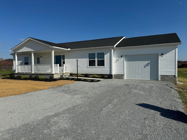 ranch-style home featuring a porch and a garage