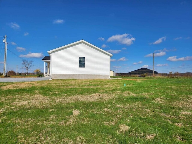 view of home's exterior with a yard