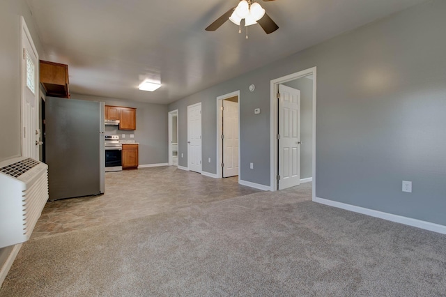 kitchen with range with electric stovetop, ceiling fan, stainless steel fridge, and light carpet