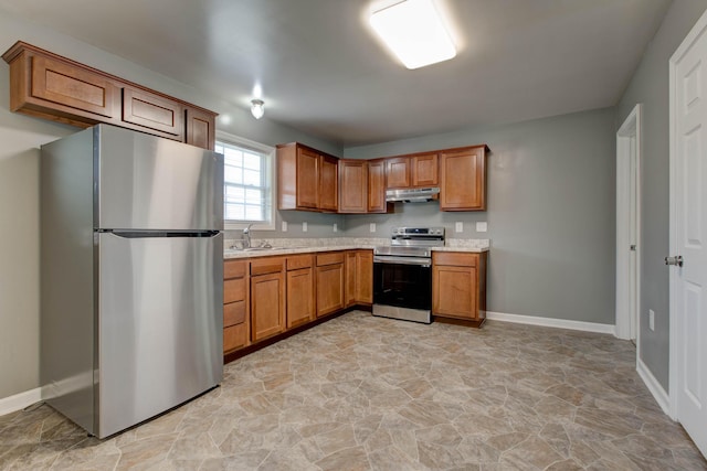 kitchen with sink, light tile floors, range with electric stovetop, stainless steel refrigerator, and light stone countertops