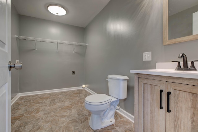 bathroom with tile flooring, toilet, and vanity