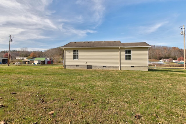 back of house with a lawn