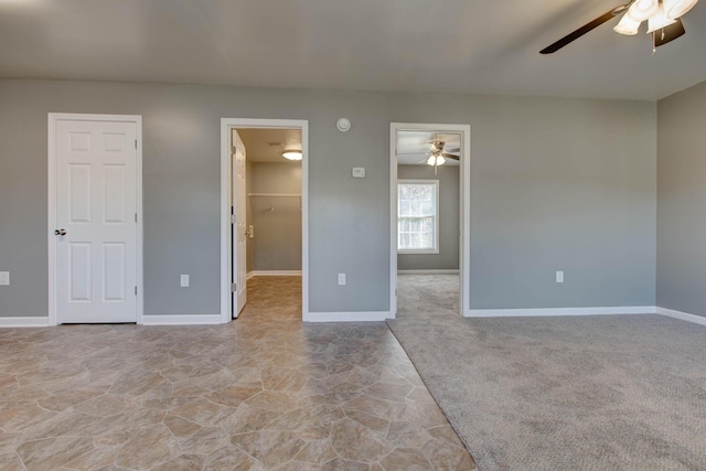 interior space with light carpet and ceiling fan