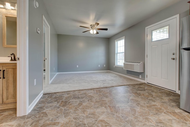 carpeted foyer entrance featuring ceiling fan and sink