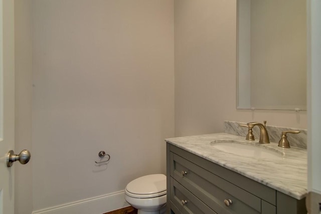 bathroom with toilet and large vanity