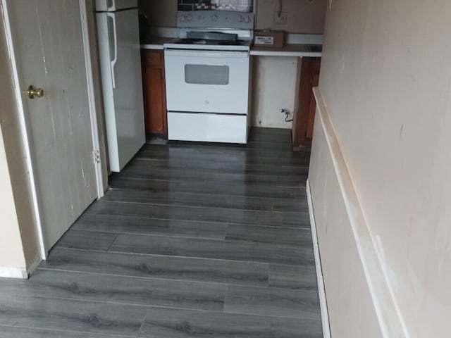 interior space featuring dark hardwood / wood-style floors and white appliances