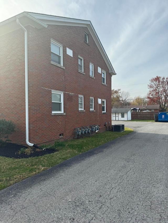 view of side of home with central AC unit