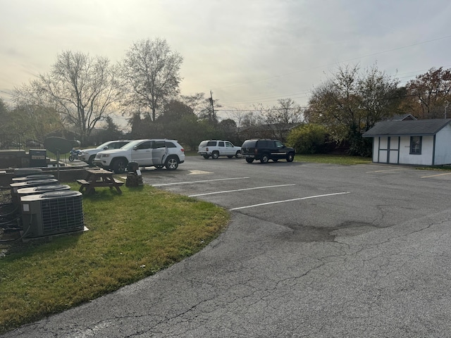 view of parking / parking lot with a lawn