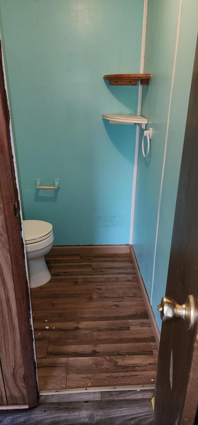 bathroom featuring hardwood / wood-style floors and toilet