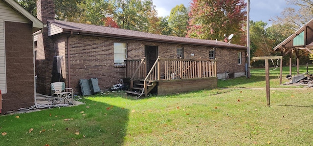 back of house with a lawn and a wooden deck