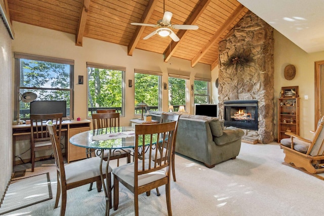 carpeted dining area featuring a fireplace, wooden ceiling, ceiling fan, and a healthy amount of sunlight