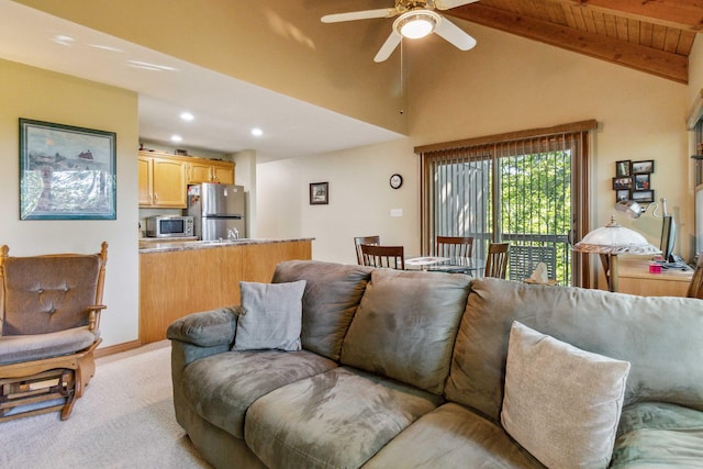 carpeted living room featuring vaulted ceiling with beams, ceiling fan, and wooden ceiling