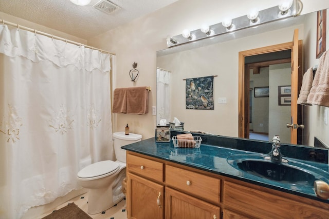 bathroom with vanity, a textured ceiling, toilet, and walk in shower