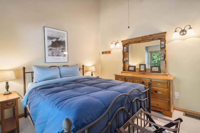 carpeted bedroom with baseboards and visible vents