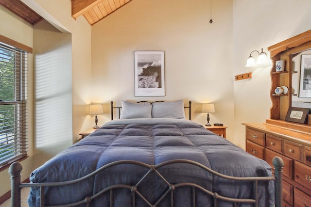 bedroom featuring lofted ceiling with beams