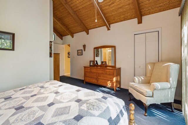 bedroom featuring dark colored carpet, beam ceiling, wood ceiling, and a closet