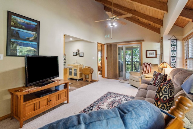 living room featuring beam ceiling, ceiling fan, carpet, and a healthy amount of sunlight