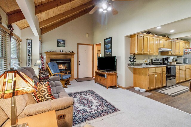 living room featuring high vaulted ceiling, sink, ceiling fan, beamed ceiling, and light hardwood / wood-style floors