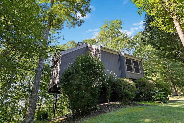 view of property exterior featuring a lawn