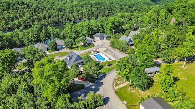 drone / aerial view featuring a wooded view