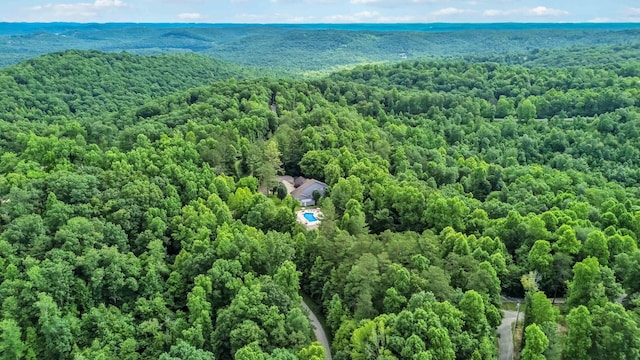 drone / aerial view featuring a forest view