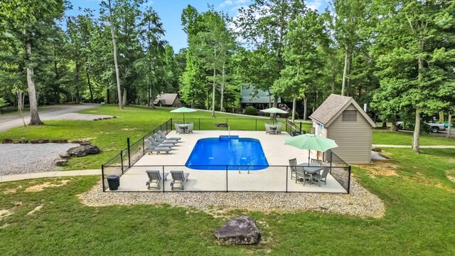 view of swimming pool featuring a patio and a lawn