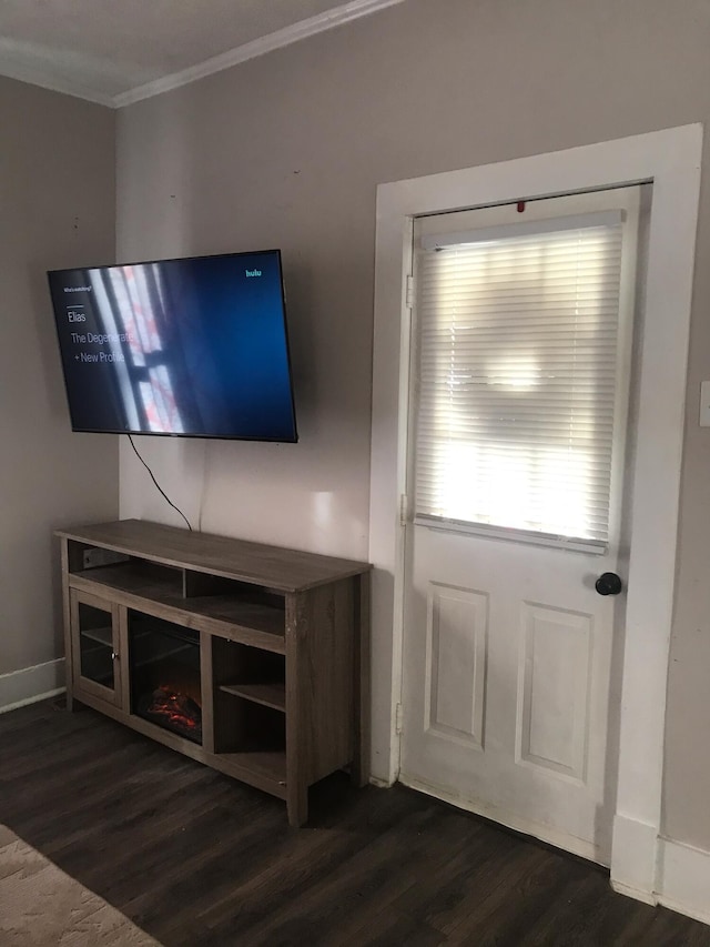 unfurnished living room featuring dark hardwood / wood-style flooring and crown molding