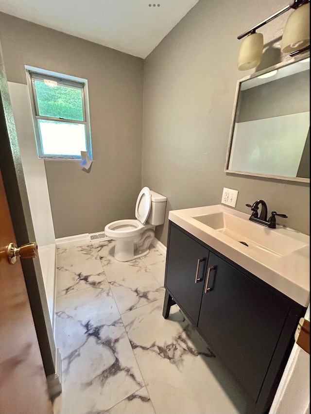 bathroom featuring tile patterned floors, toilet, and vanity