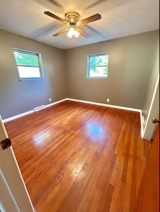 spare room featuring ceiling fan and hardwood / wood-style flooring