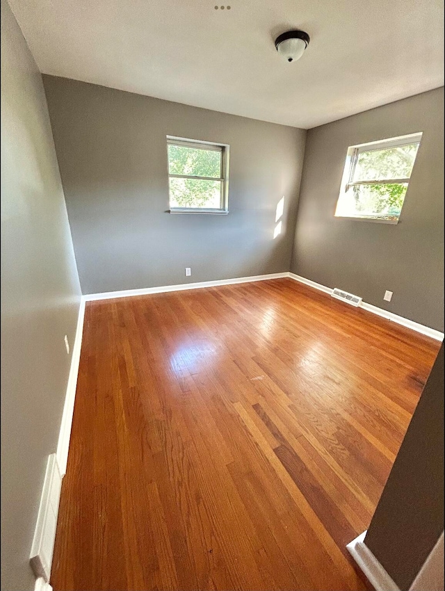 spare room with hardwood / wood-style floors