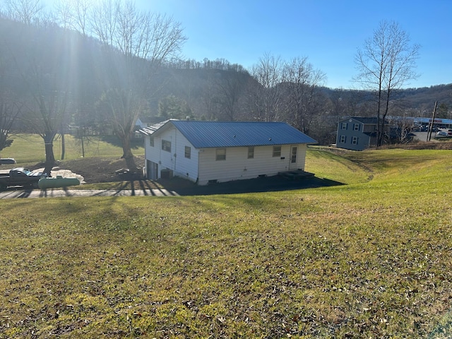 view of home's exterior with a lawn