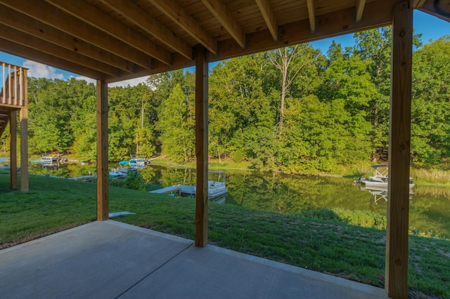 view of patio featuring a water view and a wooded view