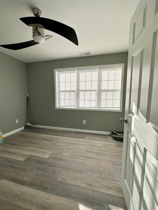 unfurnished room with ceiling fan and hardwood / wood-style floors