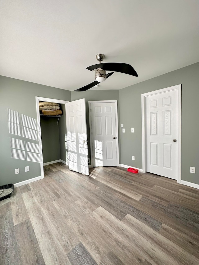 unfurnished bedroom with ceiling fan and light hardwood / wood-style floors