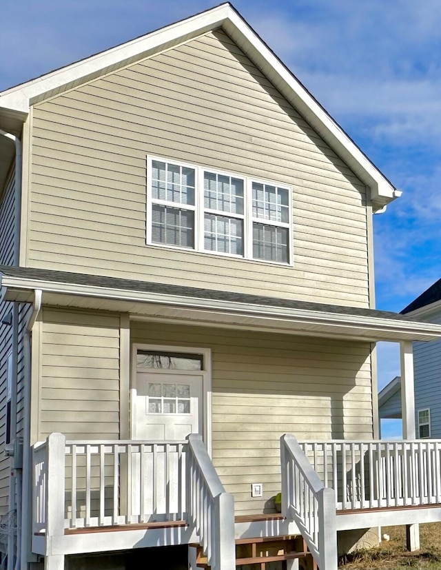 back of property with a porch