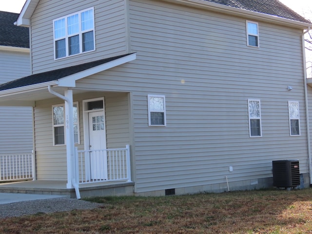 view of side of home with covered porch and cooling unit