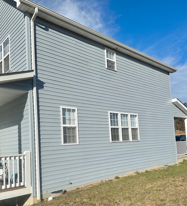 view of side of property with a yard