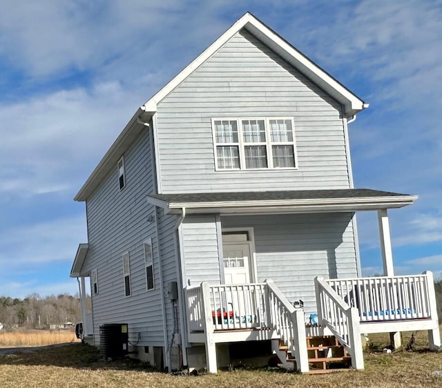 rear view of house featuring central AC unit and a porch