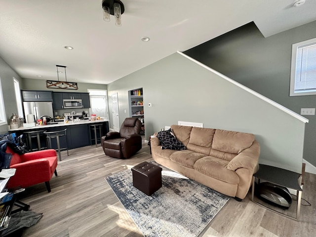 living room with lofted ceiling and light wood-type flooring