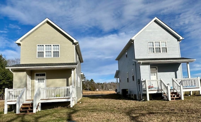 rear view of property featuring a porch, a yard, and central air condition unit