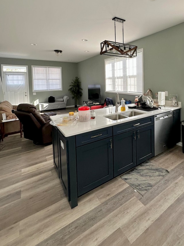 kitchen featuring stainless steel dishwasher, pendant lighting, plenty of natural light, and sink